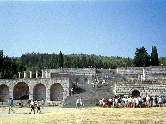 View of the archaeological area of Asklepeio with a group of tourists  